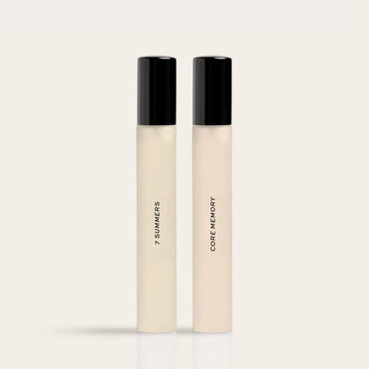 Two cylindrical fragrance bottles with black caps and cream-colored liquid labeled "7 Summers" and "Core Memory."