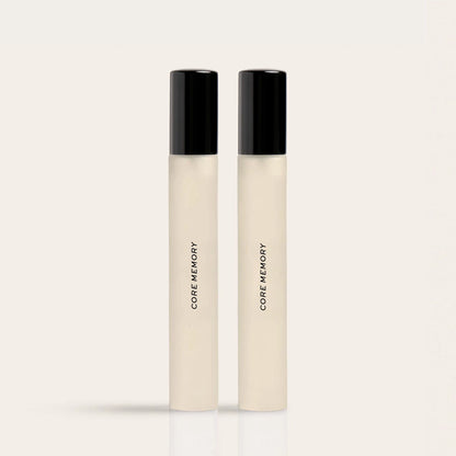 Two cream-colored spray bottles with black caps labeled "Core Memory" against a neutral background.