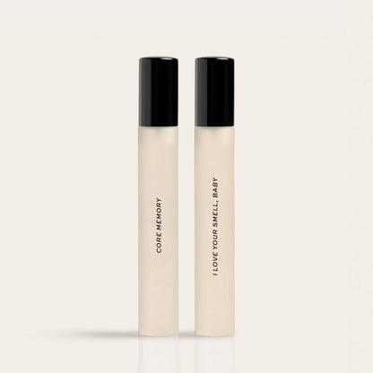 Two cream-colored roll-on bottles with black caps labeled "Core Memory" and "I Love Your Smell Baby".