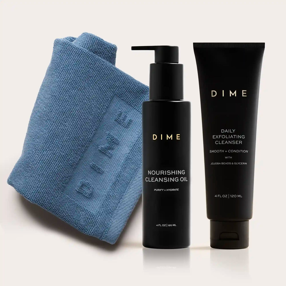 Blue textured cleansing cloth with black pump bottle of nourishing cleansing oil and black tube of daily exfoliating cleanser