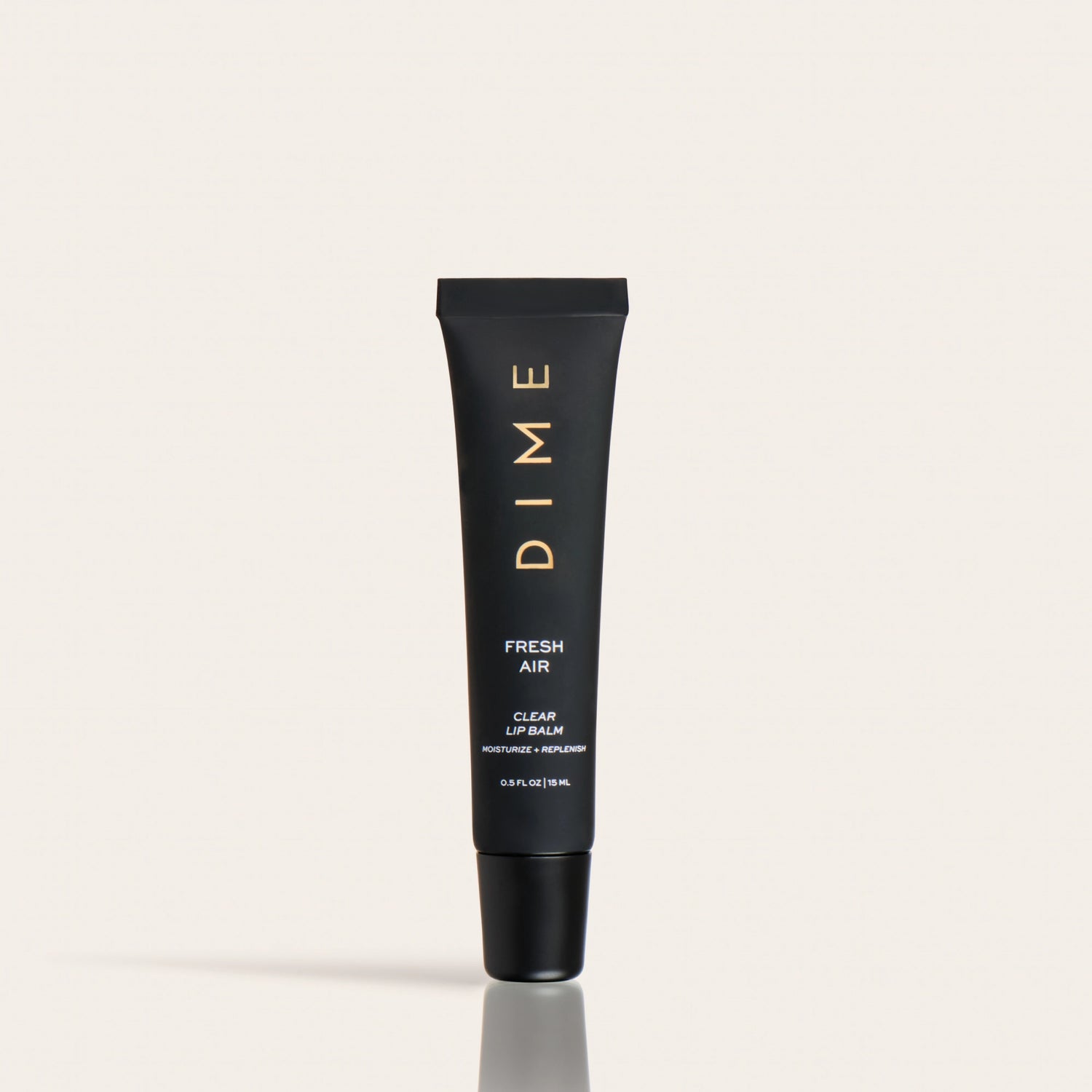 Black tube of DIME Fresh Air clear lip balm with gold lettering and black cap on neutral background.