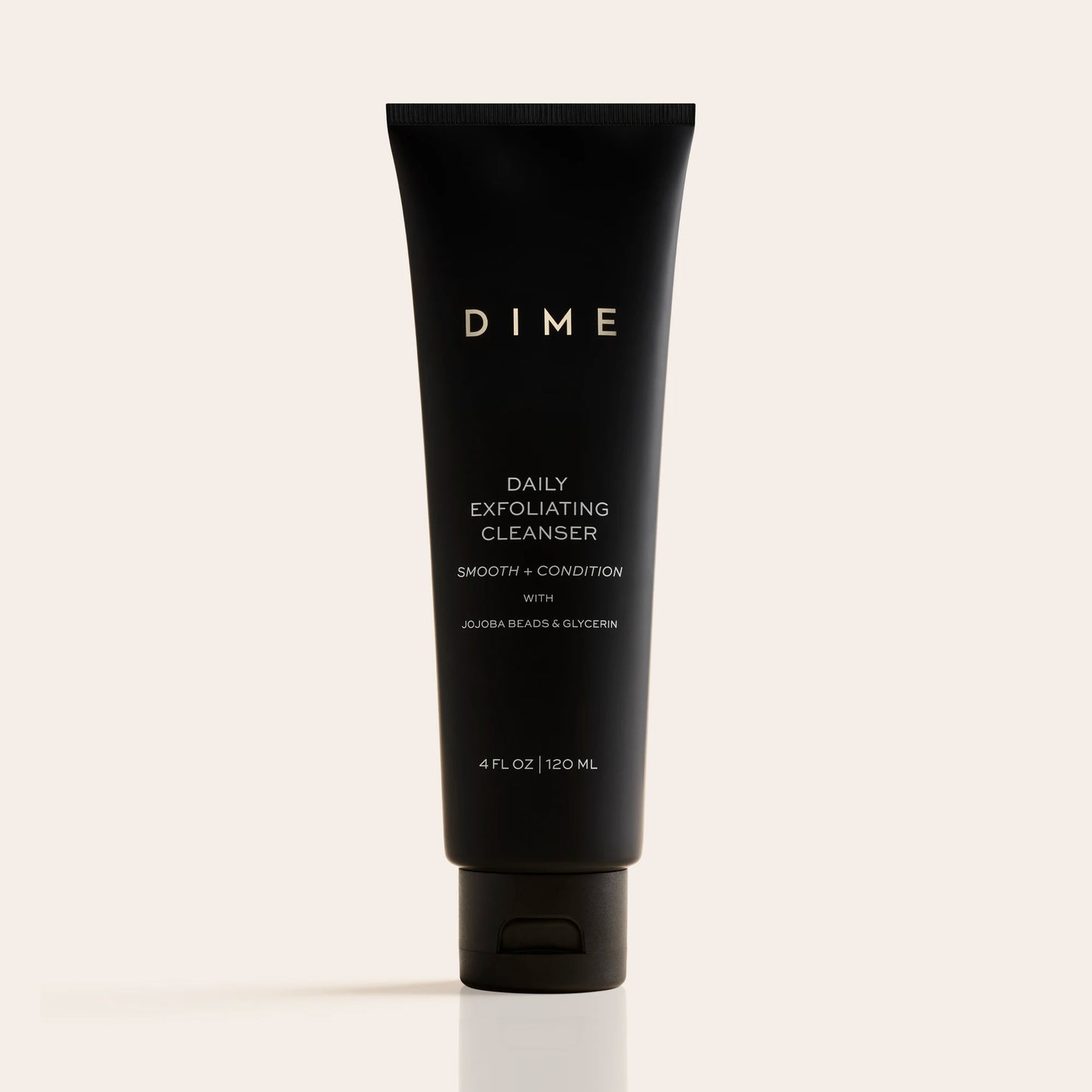 Black tube of DIME Daily Exfoliating Cleanser, 4 fl oz, with white text labeling on neutral background.