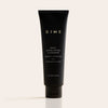 Black tube of DIME Daily Exfoliating Cleanser, 4 fl oz, with white text labeling on neutral background.