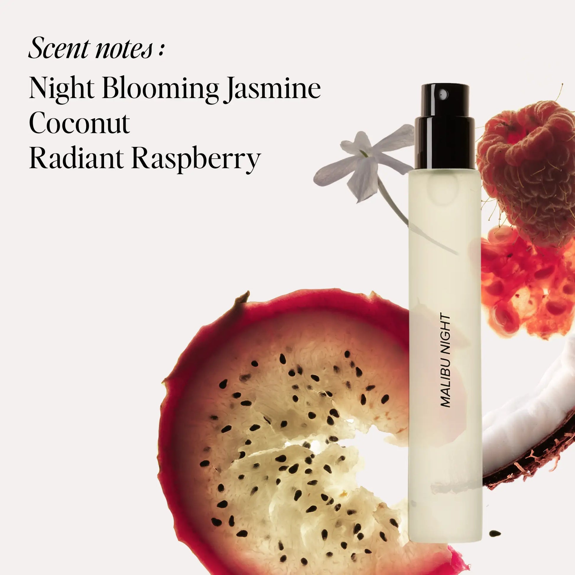 Clear glass travel spray bottle with black atomizer and "Malibu Night" text, surrounded by jasmine flowers and red fruit.